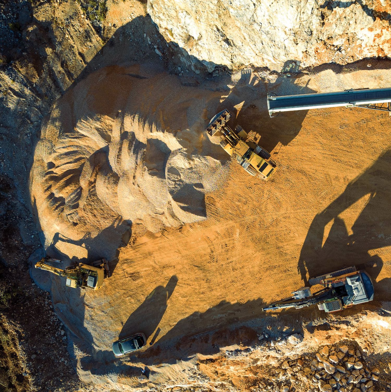 An excavator loading ore at the face